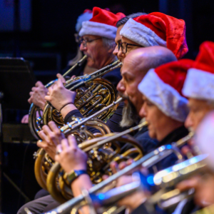 brass musicians wearing Santa caps