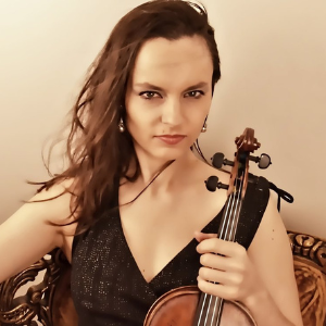 white female with long brown hair holding violin at the neck